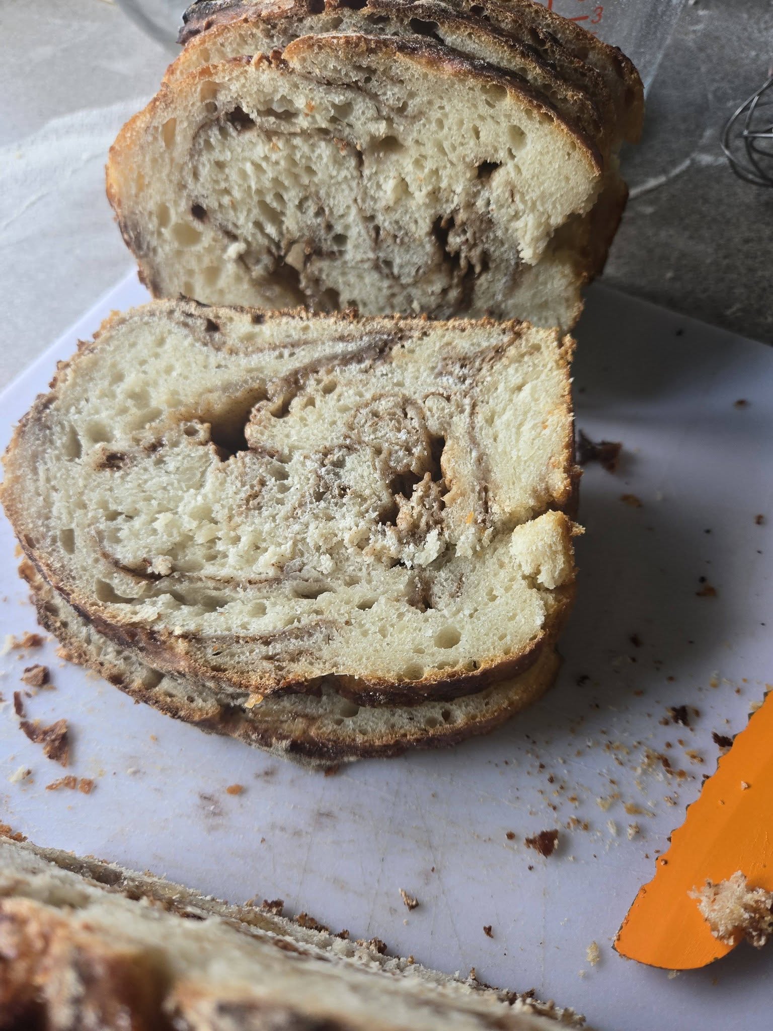 Crusty sourdough loaves cooling on a rack