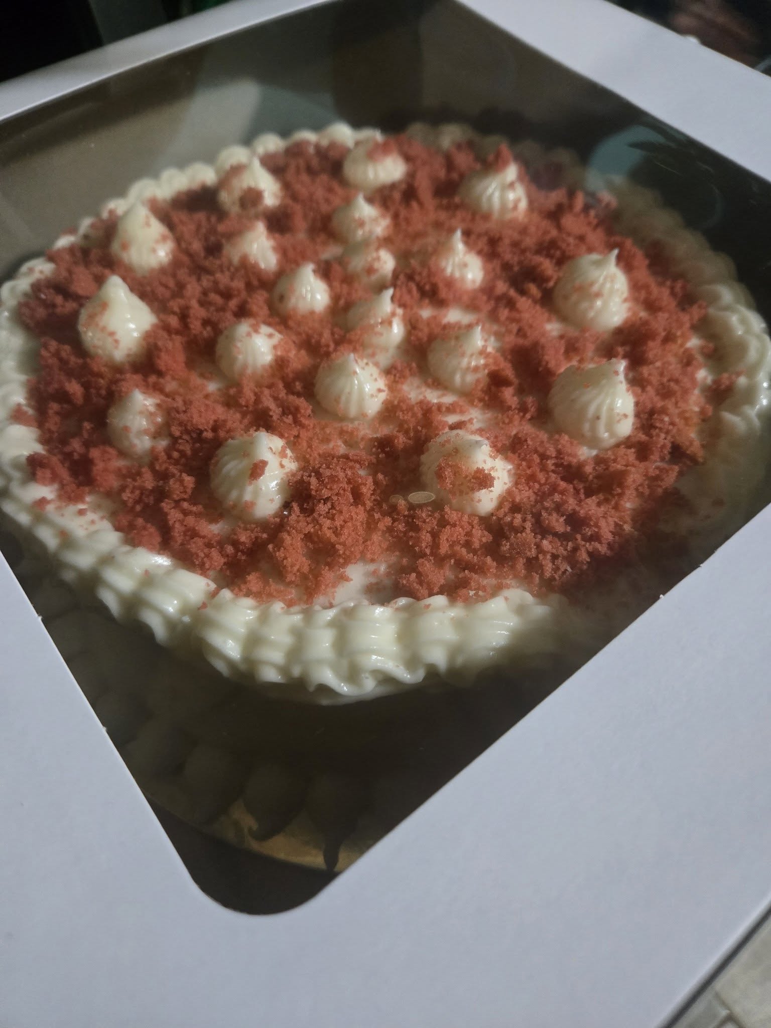 A frosted layer cake on a cake stand